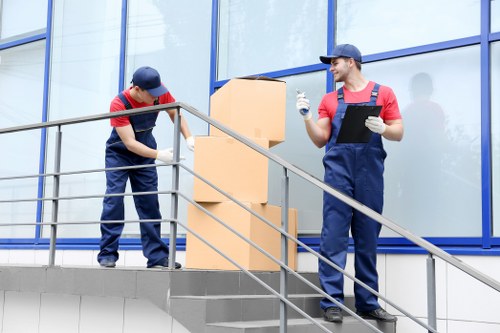 Trained movers handling furniture during a relocation in Addington
